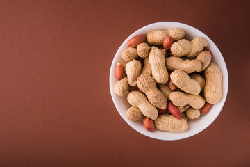 Organic peanuts in a white bowl