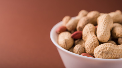 Organic peanuts in a white bowl