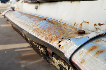 Rusty chrome car bumper. Old rustic car with a rusty bumper.