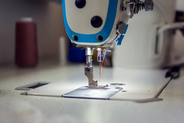 A sewing machine with equipment. Manufacture of wearing concept