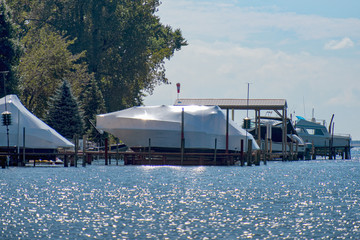 Yachts shrink wrapped for the winter along the river