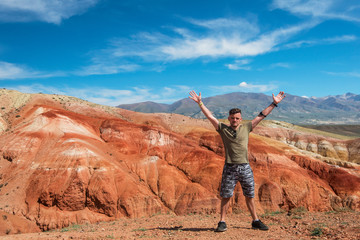 Fototapeta premium Happy man in Valley of Mars landscapes in the Altai Mountains, Kyzyl Chin, Siberia, Russia