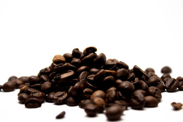 Dark brown coffee beans on a white background