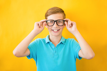 Handsome teen boy wears glasses. Poor vision and medicine concept
