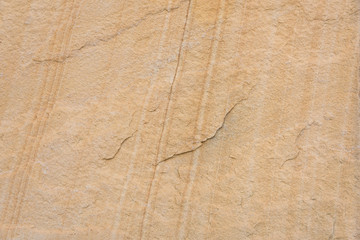 Yellow sandstone cross section texture stripes closeup