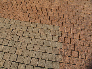 Granite paving stones laid on the road. Pavement.
