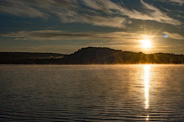 Sunrise over a Foggy Lake