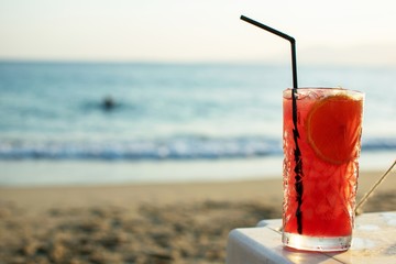 Zombie cocktail close up on the beach with nice soft background.