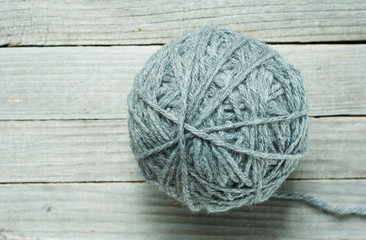 wool ball of threads on wooden table