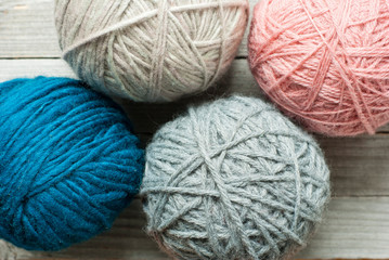 wool ball of threads on wooden table