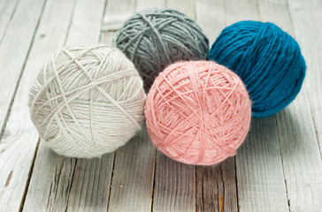 wool ball of threads on wooden table