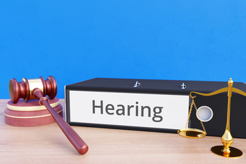 Hearing – Folder with labeling, gavel and libra – law, judgement, lawyer