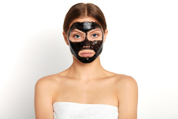 young pleasant girl taking beauty procedure at spa center, close up portrait, isolated white background, studio shot