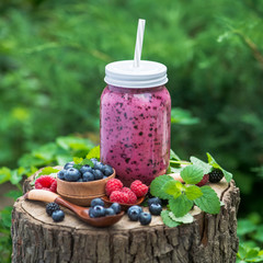 Homemade bottle with blueberry, raspberry, gooseberry smoothie and berry
