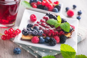 Sweet dessert cake with blackberry, raspberry, currants
