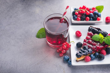 Sweet dessert cake with fresh blackberry, raspberry, currants and blueberry