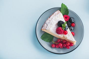 Sweet dessert cake with fresh blackberry, raspberry, currants and blueberry