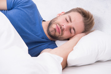 Lost in a deep sleep. Late sleeper enjoying sleep in the morning. Handsome man having sleep in bed....