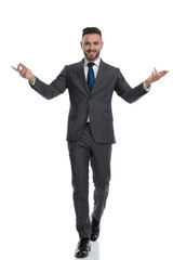 happy young businessman is walking and welcoming with hands outstretched