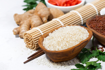 products for Japanese cuisine, rice, ginger and herbs on white background, closeup