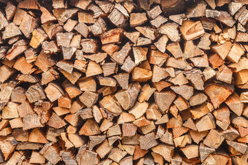 Woodpile. Background of stacked chopped logs. Heap firewood. Selective focus