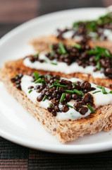 Toast with beluga lentils on garlic soy yogurt