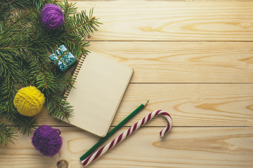 Christmas tree and yarn balls as decorations on wooden background