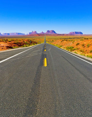 Fototapeta na wymiar View of Monument Valley on a sunny day near the border of Arizona and Utah in Navajo Nation Reservation in USA.