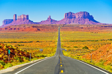 View of Monument Valley on a sunny day near the border of Arizona and Utah in Navajo Nation Reservation in USA.