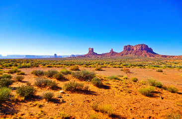 View of Monument Valley on a sunny day on the Highway 163 in Navajo Nation Reservation in USA.