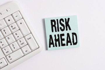 Word writing text Risk Ahead. Business photo showcasing A probability or threat of damage, injury, liability, loss White pc keyboard with empty note paper above white background