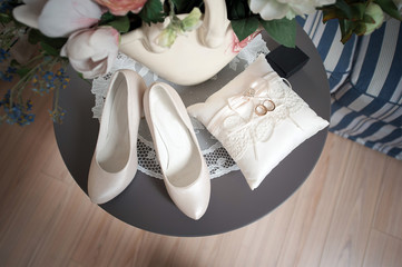 Shoes, wedding ring pads, rings on the table