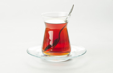 Fototapeta na wymiar Glass Turkish brewed black tea isolated on white background. Turkish traditional hot drink 