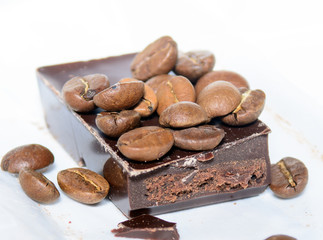 on the chocolate bar and around are coffee beans. Concept - Chocolate and Coffee
