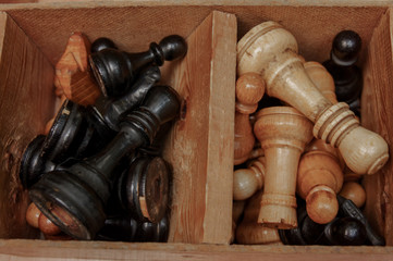 Open chess box with some black and white chess figures inside