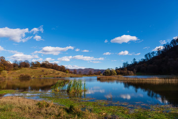 Fototapeta na wymiar Beautiful landscape with Tsover lake and arrounded mountains and trees, Armenia