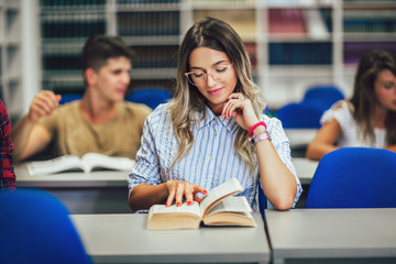 Portrait of a beautiful student in a library