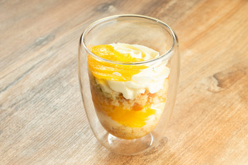 Delicious trifle dessert in glasses. Dessert with whipped cream, fruit, mango. Sweets after lunch. Food photo for recipe or menu