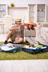 Fototapeta premium Young couple preparing for trip