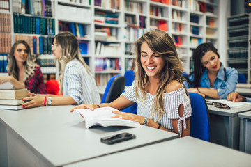 Portrait of a beautiful student in a library
