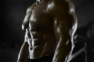 Handsome strong athletic men pumping up muscles workout fitness and bodybuilding concept background...