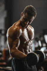 Fototapeta na wymiar Handsome strong athletic men pumping up muscles workout fitness and bodybuilding concept background - muscular bodybuilder fitness men doing arms abs back exercises in gym naked torso.