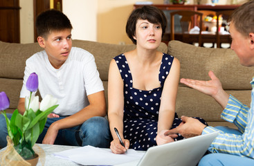 Woman with teenage son signing papers