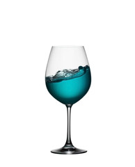 Splash of blue drink in glass on white isolated background. The splashing of blue water is like a sea wave in a glass. A splash of blue cocktail in a wine glass closeup.