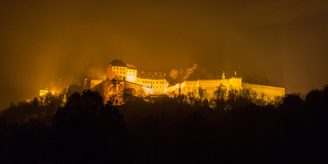 The fortress Koenigstein shrouded in fog at night, Germany