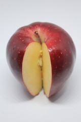 One Whole Red Delicious Apple Sliced on a White Background