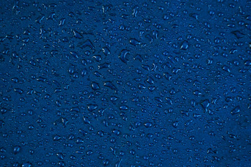 View texture blue synthetic waterproof clothing.Water drops on waterproof nylon. Rain drops on...