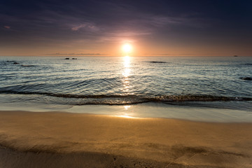 Fototapeta premium sunrise view at the Lake Malawi, waves rolling smoothly on the beach, Africa
