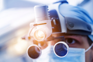 Portrait of spinal surgeon in operating room with surgery equipment.