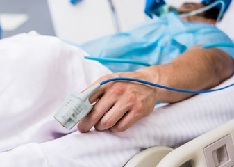 Doctors give resuscitation to a male patient in the emergency room. Cardiac massage